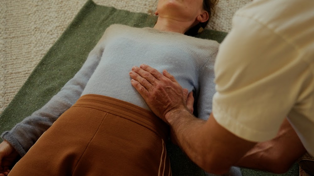 A guided breathwork session, hand resting on the chest